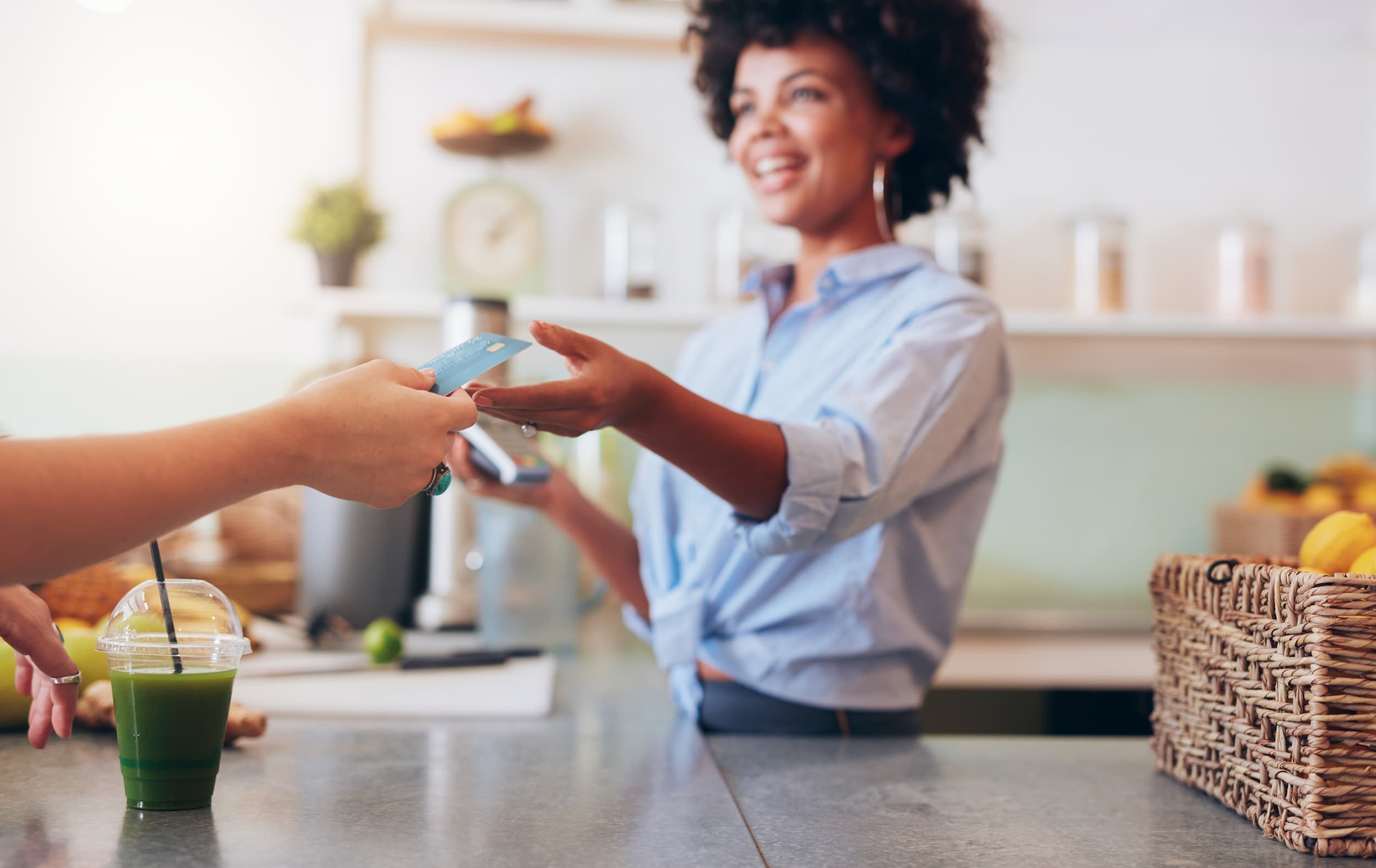 Smiling staff processing customer refund at counter